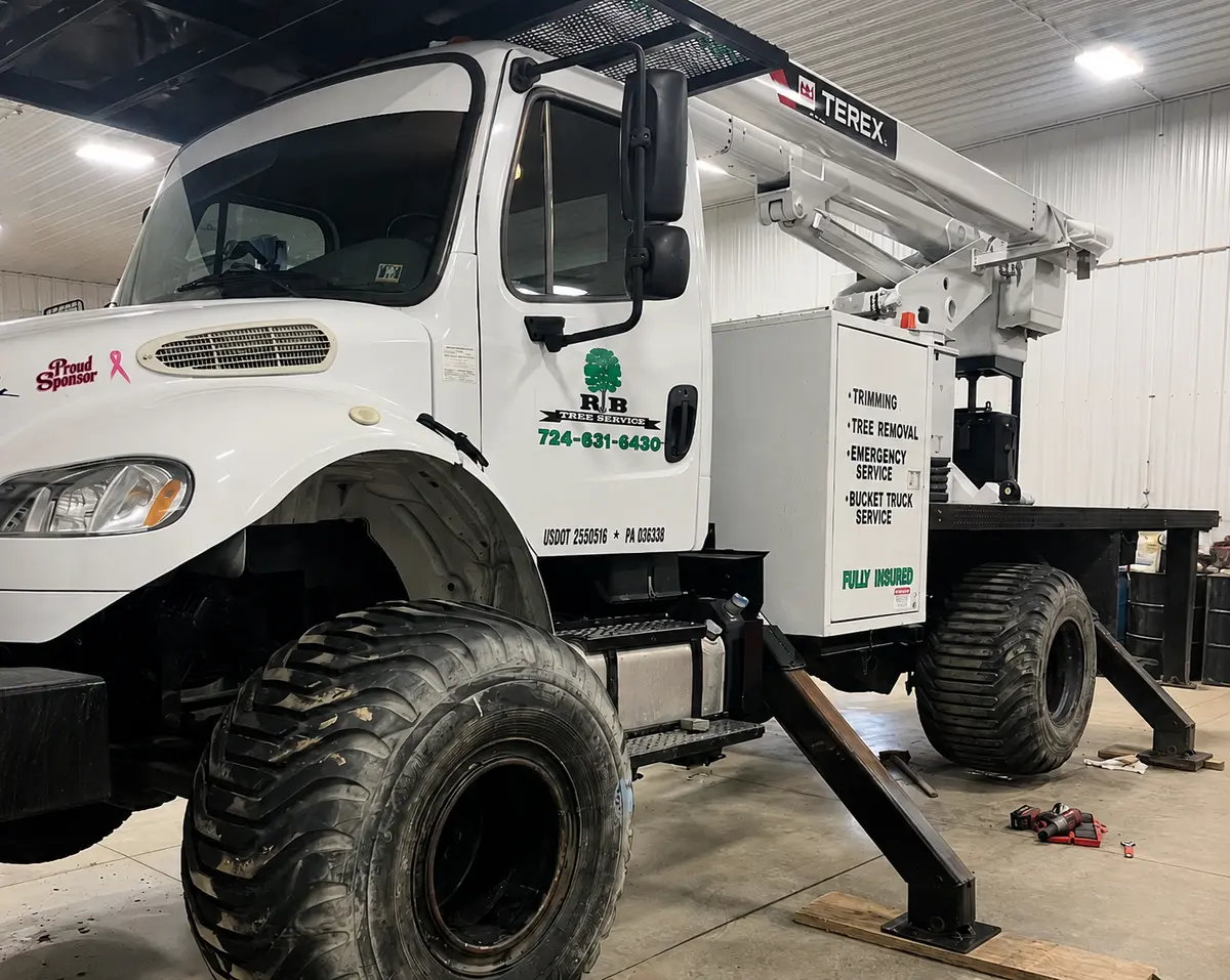 RB Tree Service bucket truck with company logo and boom