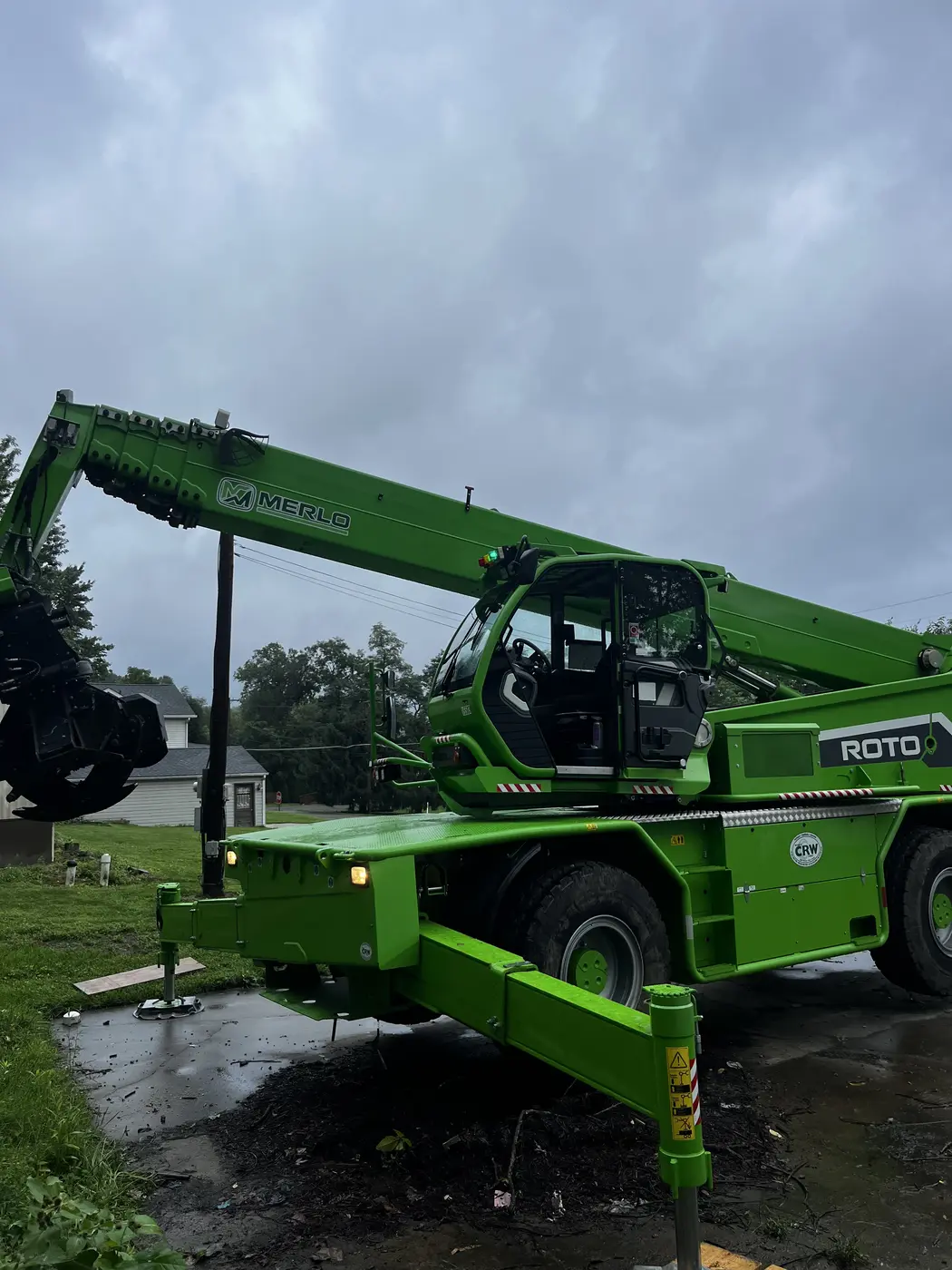 Green Merlo crane used for difficult tree removals